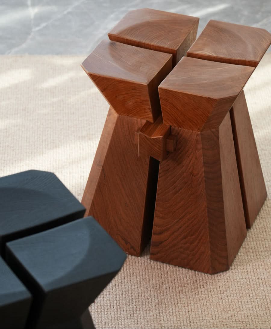 Modern Geometric Wooden Stool in natural wood finish and black, on a textured rug.